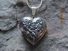 "Beautiful silver plated heart locket. It holds 2 photos and/or a treasured keepsake, please see the photos for size. The locket comes with a matching 20\" silver plated snake chain. If you would like a different length, please leave a note at checkout or just message me. Please do visit my shop, there is so much to see and something for everyone. Thanks so much...Lisa" Nickel-free Heart Locket Necklace For Wedding, Nickel Free Heart Locket Necklace For Wedding, Silver Heart Charm Locket Necklace For Wedding, Silver Heart Locket Necklace For Wedding, Sterling Silver Locket Necklace For Wedding On Valentine's Day, Silver Heart Pendant Locket Necklace For Weddings, Silver Heart-shaped Jewelry With Rose Design, Heart-shaped Rose Design Jewelry For Wedding, Heart-shaped Rose Design Wedding Jewelry