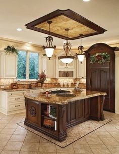 a large kitchen with marble counter tops and an island in front of the stove top