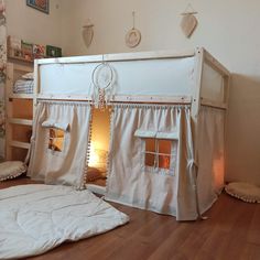 a bunk bed with curtains on the top and bottom is next to a small child's bed