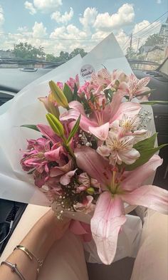 a bouquet of pink flowers in someone's hand