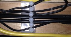 several wires are connected to each other in a box with yellow cords and white caps