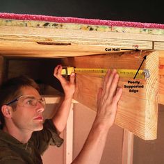 a man measuring the width of a piece of wood