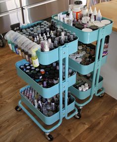 two rolling carts with bottles on them in a kitchen