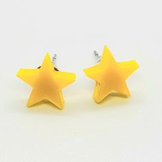 Simple, cute, and yellow. No real description needed...unless you like, can't see. In which case, they're little stars made from acrylic, and they'd look great on you.  Product Description:  Dimensions: 1 cm x 1 cm x 3 mm Lightweight but sturdy High quality glossy Bright Yellow Acrylic  Metal studs are hypoallergenic stainless steel Ships with a small jewelry box with both rubber and stainless steel earring backs. Cheap Yellow Minimalist Earrings, Yellow Star Earrings, Silly Hats, Star Earring, Star Clothing, Yellow Accessories, Yellow Star, Small Jewelry Box, Star Earrings Stud