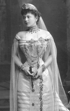 an old black and white photo of a woman in a wedding dress with a veil