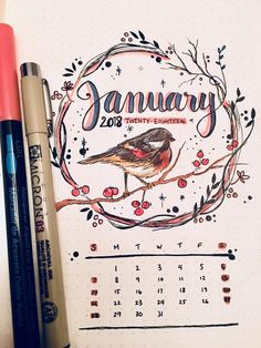 a calendar with a bird sitting on top of it next to some markers and pens