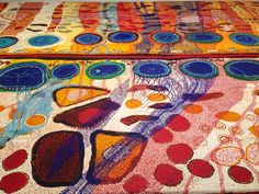 an artistically designed table cloth with circles and dots on the top, in bright colors