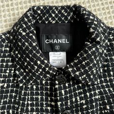 Elegant And Timeless Chanel. Perfect Condition. No Signs Of Wear. Black And White Tweed Boucle Blazer, With Subtly Black Metallic Specs Throughout. Size 36. Fits Xs/S. 2 Subtle Pockets In Front. Black And Silver Monochromatic Buttons Are Also In Perfect Condition. Silk Lining With Monochromatic Flowers. Slight Shoulder Pads. Designer Tweed Outerwear For Business, Classic White Wool Tweed Jacket, Designer Tweed Outerwear For Work, Designer Black Tweed Jacket, Designer Black Tweed Jacket With Long Sleeves, Designer Black Tweed Long Sleeve Jacket, Monochromatic Flowers, Chanel Jackets, Black White Blazer