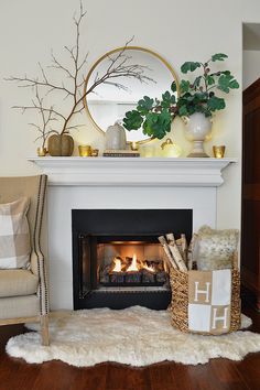 a living room with a fire place in the fireplace and decorations on the mantel