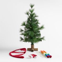 a small christmas tree with scissors and other decorations