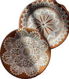 two brown and white plates sitting on top of each other