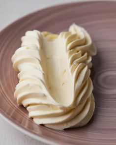 a plate that has some kind of desert on it with icing in the middle