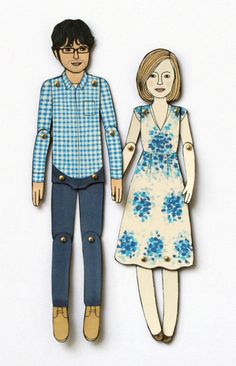 a paper cutout of a man and woman holding hands, standing next to each other