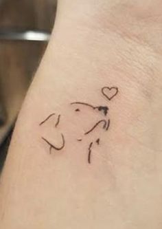 a small dog with a heart on it's side tattoo design for the wrist