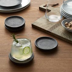 a wooden table topped with plates and bowls filled with food on top of each other