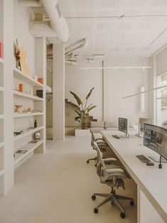 an empty office with desks and computer screens