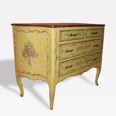 an old dresser painted yellow with floral designs