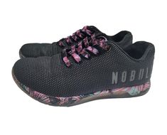 Elevate your training with these limited edition Nobull Midnight Palm Trainer Shoes. Made with a blended SuperFabric upper material and fabric lining, these shoes are designed for comfort and breathability during any activity. The lace-up closure ensures a secure fit while the rubber outsole provides traction and durability. Perfect for gym and training, track and field, walking, school, volleyball, cross-training, CrossFit, running, and jogging, these shoes are versatile and suitable for any occasion. The cushioned insole material and lightweight design make them ideal for summer, fall, and spring seasons. The black and pink color with a solid pattern and palm  and floral theme adds a stylish touch to your activewear, casual or workwear outfit. In good pre loved condition. Please see phot School Volleyball, Trainer Shoes, Floral Theme, Black And Pink, Cross Training, Track And Field, Shoes Trainers, Solid Pattern, Summer Fall