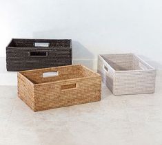 three baskets sitting on the floor next to each other