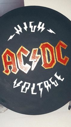 a black frisbee with the words ac / dc written on it