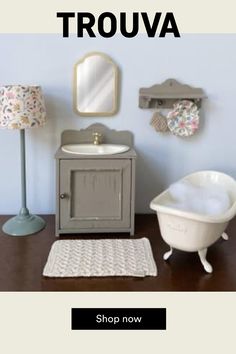 a bathroom with a sink, mirror and bathtub next to a rug on the floor