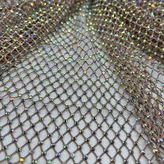 Diamond Fishnet is a high quality fabric ideal for high fashion concepts, swim cover ups, couture, and dancewear. The rhinestones are adhered with a strong grade adhesive to secure the stones in place. The fabric is designed to provide a luxurious, shimmering texture ideal for beachwear and other special occasions. The adhesive bonds the rhinestones to the fabric, allowing them to remain in place through washing and wear. This fabric is lightweight and strong, withstanding the test of time. The Dusty Rose Color, Office Siren, Cover Ups, Bridal Tiara, Fabric Texture, Swim Cover, Rose Color, Stretch Lace, Lace Fabric