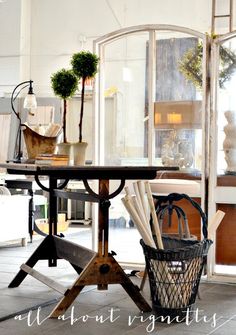 a table with chairs and vases on it