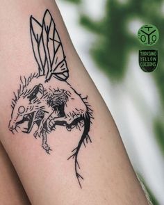 a tattoo on the leg of a woman with a dragon and bird design on it