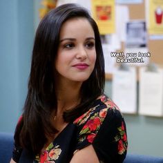 a woman sitting in an office chair with a quote on the wall behind her that reads, well you look beautiful