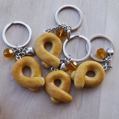 five different shaped doughnuts are sitting on a wooden table with rings around them