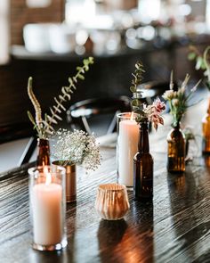 candles and vases are sitting on a table