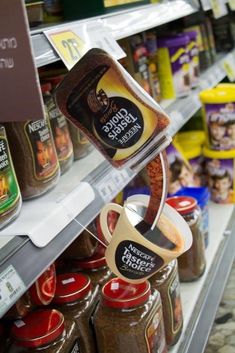 an assortment of spices and seasonings on display in a grocery store's shelf