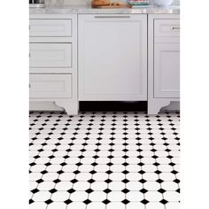 a kitchen with black and white floor tiles