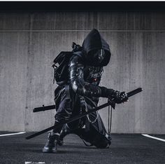 a person in a black outfit with two swords and a backpack on their back, crouching down