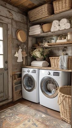 a washer and dryer in a room with baskets on the shelves above them