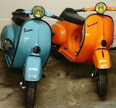 two scooters parked next to each other in a garage