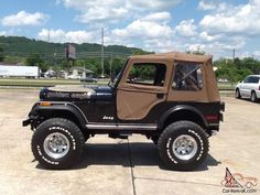 a black jeep parked in a parking lot