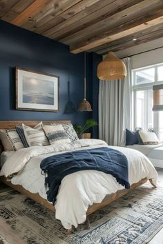 a bedroom with blue walls and white bedding in the center is an area rug that matches