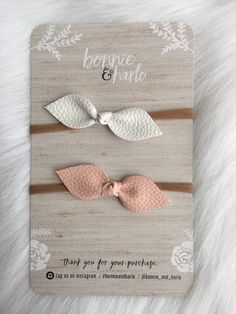 two little bows are on top of a card with the words bonnie and charlotte written in white