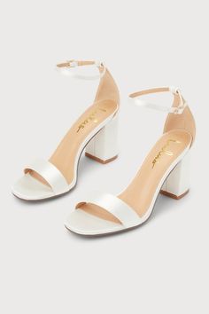 You're certain to step up your style essentials when you add the Lulus Arylee White Satin Ankle Strap Heels to your closet! Sleek satin shapes a single toe strap, an almond-shaped toe bed, and a wrapped block heel. A dainty ankle strap rises from the sturdy heel cup and secures with a gold buckle. 3" Wrapped Block Heel. Cushioned Insole. Felted Rubber Sole Has Nonskid Markings. Man Made Materials. Imported. Lulus | Arylee White Satin Ankle Strap Heels. White Lulus Heels, White Prom Shoes High Heels, Wedding Shoes Bride Simple, Cute Shoes With Dresses, Quince Shoes Heels White, Cute Heels White, Cute Shoes For Prom, White Heels Stilettos, Hoco Shoe Ideas