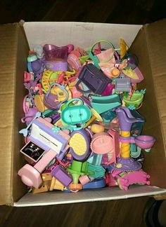 a box filled with lots of toys on top of a wooden floor