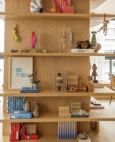 shelves with books, vases and pictures on them