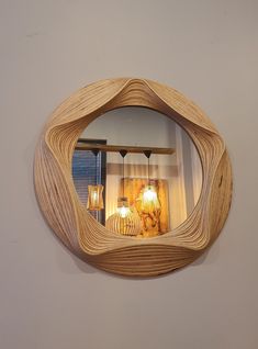 a mirror that is made out of wood and has lights on the side of it