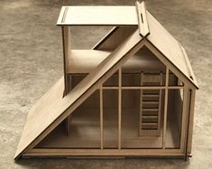 a wooden model of a house on the ground