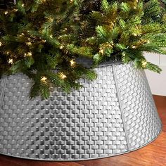 a christmas tree in a metal basket with lights