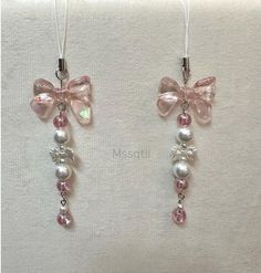 two necklaces with bows and pearls on them