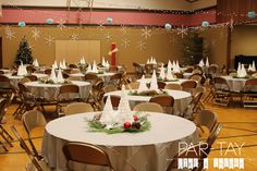 a banquet room set up for christmas with tables and chairs