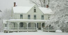 a large white house covered in snow next to some trees and bushes with the words how many of you like this big farm house?