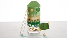 a st patrick's day treat in a glass with gold coins next to it