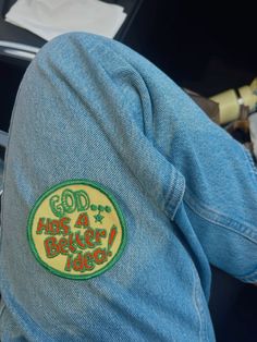 the back of someone's jean jacket that says god has a better idea